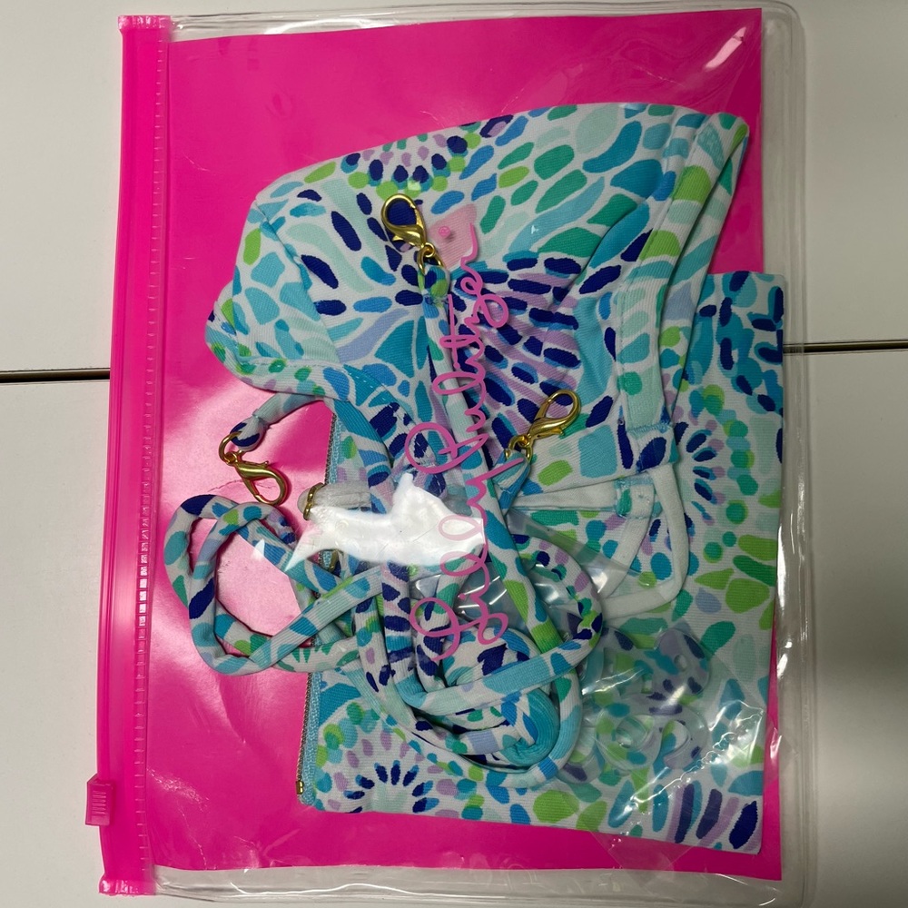 Lilly Pulitzer mask, pouch with mask strap and Lilly plastic piece.